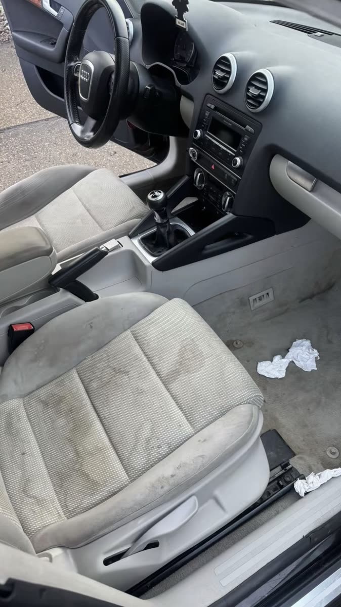 Stained car seat before shampoo extraction